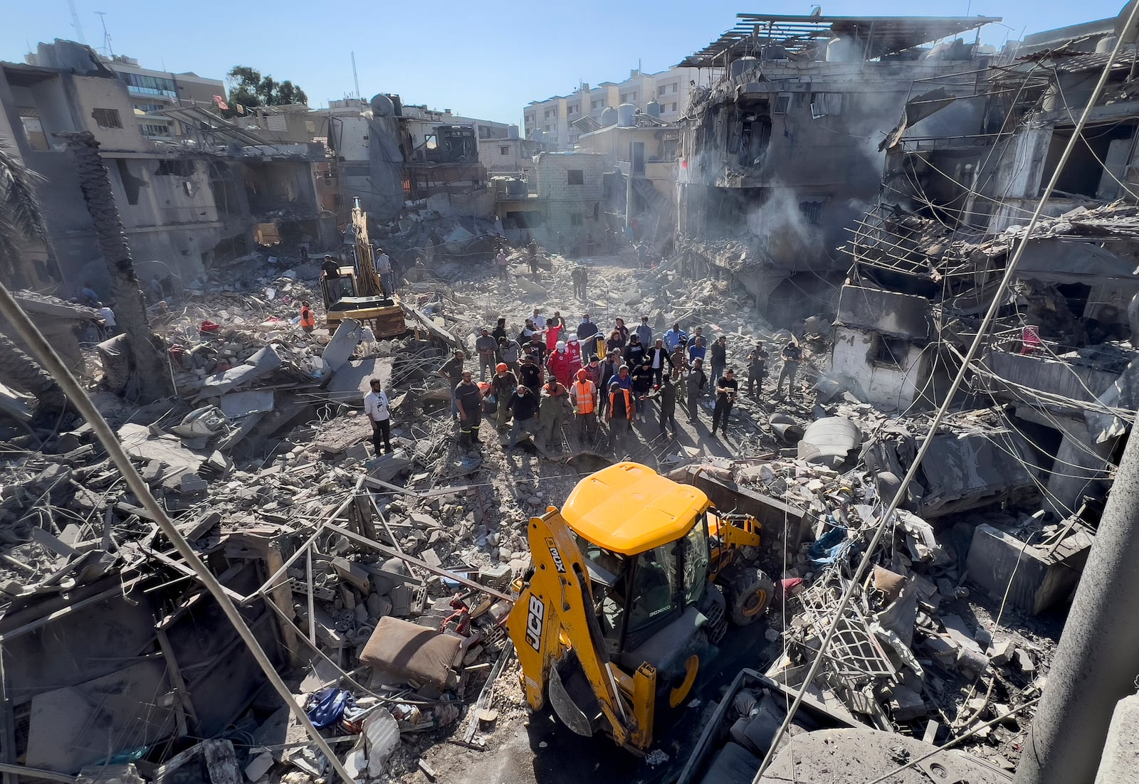 Rescue workers search for victims at a popular neighbourhood that was hit Monday night by Israeli airstrikes, south of Beirut, Lebanon, Tuesday, Oct. 22, 2024. (AP Photo/Hussein Malla)