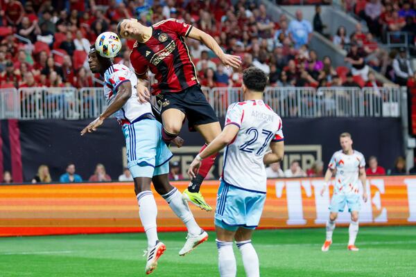 Atlanta United forward Giorgos Giakoumakis challenges Chicago Fire defender Carlos Terán for the ball during the first half of Atlanta United's 3-0 win Sunday at Mercedes-Benz Stadium. 
 Miguel Martinez/miguel.martinezjimenez@ajc.com