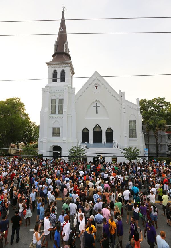 Hundreds of people stream from a public memorial, community prayer and healing vigil at the College of Charleston to “Mother” Emanuel AME Church two days after the shooting in June 2015. CURTIS COMPTON / CCOMPTON@AJC.COM