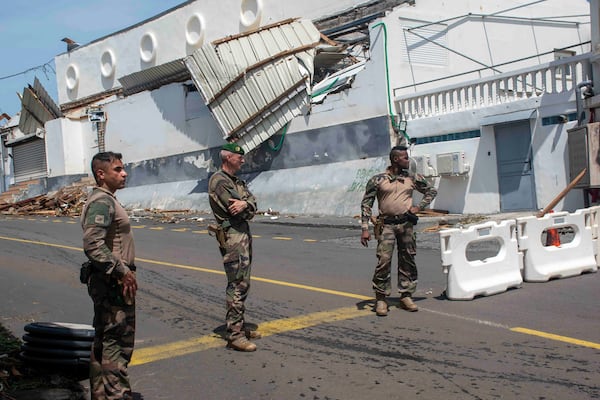 This photo provided Sunday Dec.15, 2024 by the French Army shows soldiers at a checkpoint in the French territory of Mayotte in the Indian Ocean, after Cyclone Chido caused extensive damage with reports of several fatalities. (Etat Major des Armées via AP)