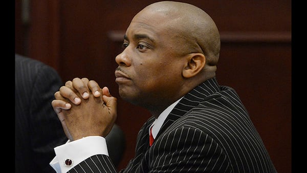 Clayton County Sheriff Victor Hill listens to defense attorney Drew Findling making closing arguments during the sheriff’s 2013 trial on 27 felony charges. JOHNNY CRAWFORD / JCRAWFORD@AJC.COM