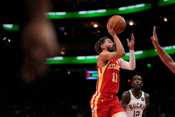 Atlanta Hawks guard Trae Young (11) shoots in the first half of an NBA basketball game against the Milwaukee Bucks, Tuesday, March 4, 2025, in Atlanta. (AP Photo/Brynn Anderson)