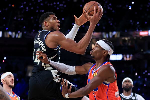 Milwaukee Bucks forward Giannis Antetokounmpo (34) shoots against Oklahoma City Thunder guard Shai Gilgeous-Alexander (2) during the second half of the championship game in the NBA Cup basketball tournament Tuesday, Dec. 17, 2024, in Las Vegas. (AP Photo/Ian Maule)