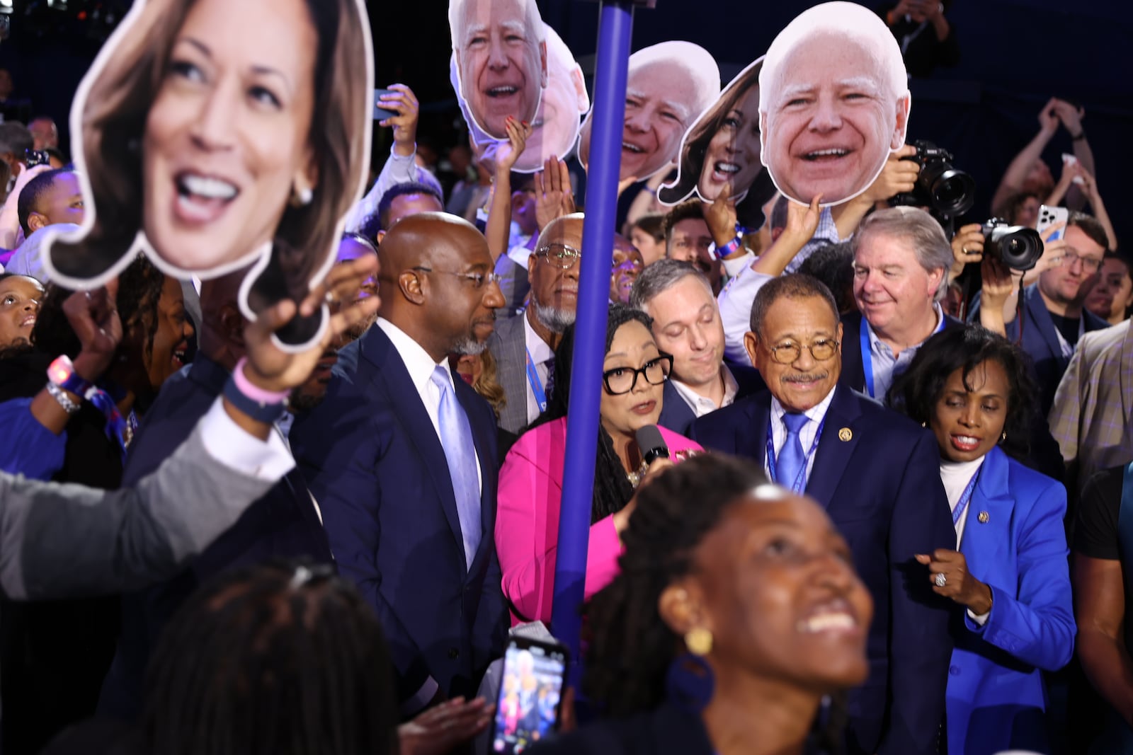 Georgia delegates, including Sen. Raphael Warnock, second from left, U.S. Rep. Nikema Williams, and U.S. Rep Sanford D. Bishop, officially nominate Kamala Harris as the Democratic presidential candidate during the roll call of the states on Tuesday, Aug. 20, 2024, at the Democratic National Convention in Chicago. (Arvin Temkar/AJC)