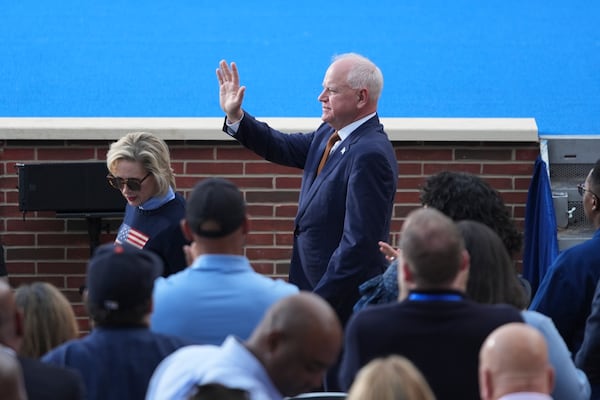 Minnesota Gov. Tim Walz waves as he arrives ahead of Vice President Kamala Harris delivering a concession speech for the 2024 presidential election, Wednesday, Nov. 6, 2024, on the campus of Howard University in Washington. (AP Photo/Stephanie Scarbrough)