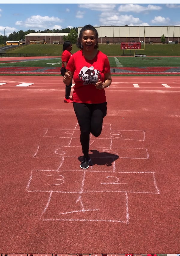 40-plus double Dutch member Gloria Goolsby, 58, plays hopscotch at a Douglasville meet-up. Childhood games are a part of the weekly group meetings. Goolsby jumps with the Douglasville and McDonough sub clubs. She recalled jumping rope all the time as a child growing up in Chicago.