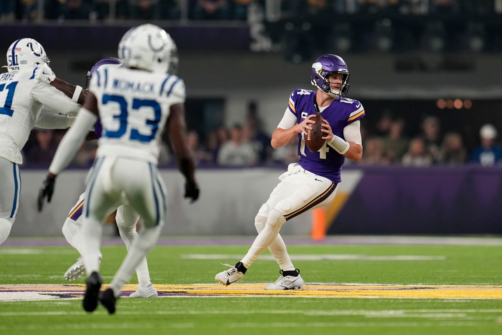 Minnesota Vikings quarterback Sam Darnold (14) looks to pass during the first half of an NFL football game against the Indianapolis Colts, Sunday, Nov. 3, 2024, in Minneapolis. (AP Photo/Abbie Parr)