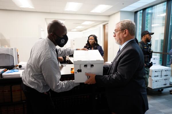 Workers at Atlanta City Hall seal boxes containing over 100,000 signatures with a petition by opponents of the police and firefighter training center who want the project placed on a ballot for public consideration. Miguel Martinez /miguel.martinezjimenez@ajc.com