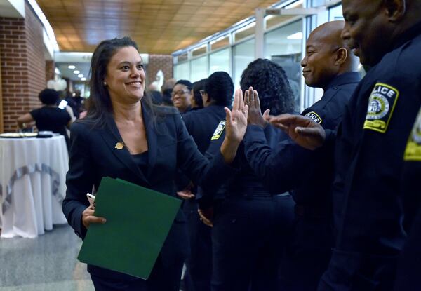 Atlanta Public Schools Superintendent Meria Carstarphen high fives Atlanta school district police department members before a swearing-in ceremony on Thursday, June 23, 2016. AJC FILE PHOTO HYOSUB SHIN / HSHIN@AJC.COM