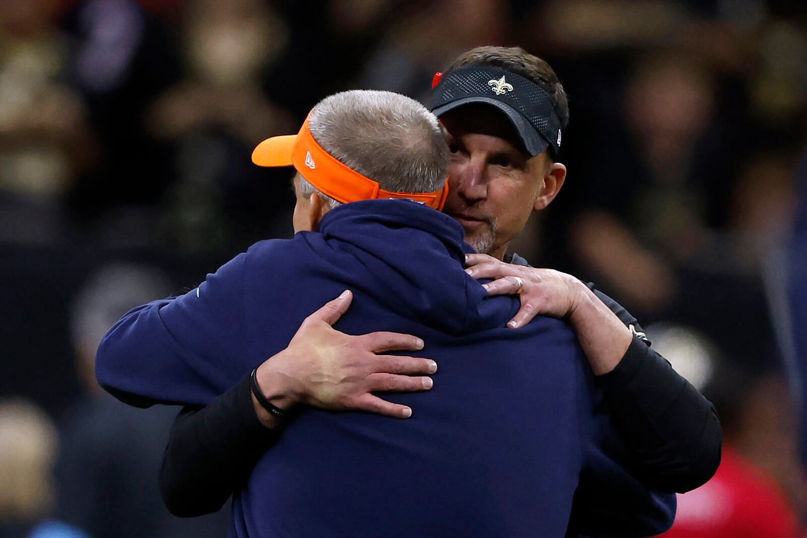 New Orleans Saints head coach Dennis Allen, right, hugs Denver Broncos head coach Sean Payton before an NFL football game, Thursday, Oct. 17, 2024, in New Orleans. (AP Photo/Butch Dill)