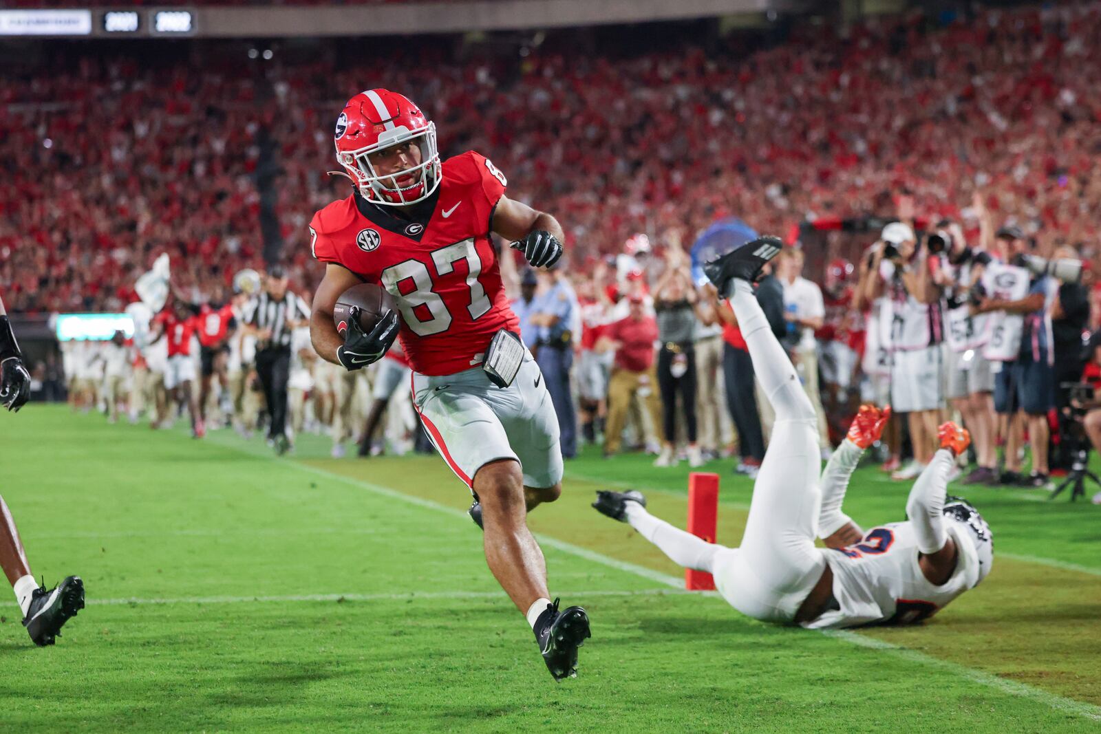 Georgia wide receiver Mekhi Mews (87) scores a 54-yard touchdown reception past UT Martin safety Robert Daniel Jr. (22) during the third quarter at Sanford Stadium, Saturday, September 2, 2023, in Athens, Ga. Georgia won 48-7. (Jason Getz / Jason.Getz@ajc.com)