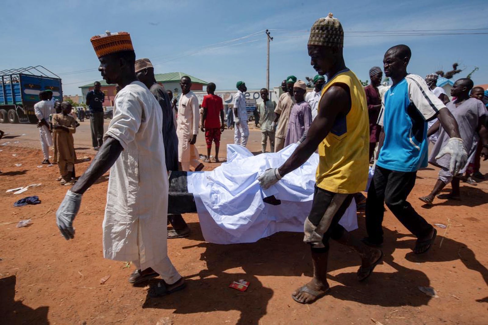 People carry the body of a victim of a tanker explosion before a funeral in Majiya town, Nigeria, Wednesday, Oct. 16, 2024. (AP Photo/Sani Maikatanga)