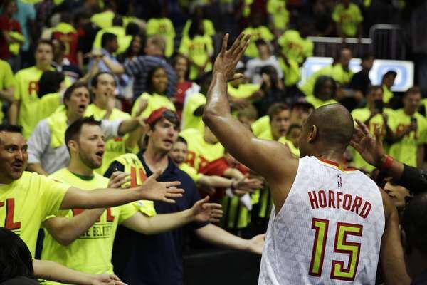 Fans cheer as Al Horford of the Hawks walks off the court after the Hawks beat the Boston Celtics in Game 1 of a first-round NBA basketball playoff series Saturday, April 16, 2016, in Atlanta. (AP Photo/David Goldman)