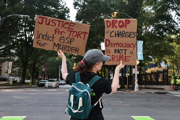 A demonstrator stands outside of the attorney general’s office in Downtown Atlanta on Friday, September 8, 2023. On Tuesday, Georgia Attorney General Chris Carr announced that a total of 61 training center activists have been charged with violating the state’s Racketeer Influenced and Corrupt Organizations act. (Natrice Miller/ Natrice.miller@ajc.com)