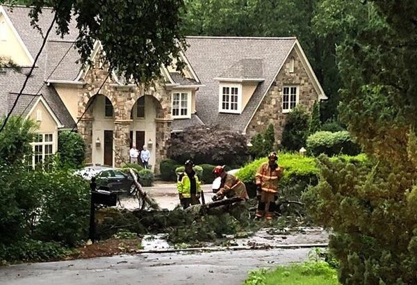 Marietta firefighters are working to clear downed trees Monday evening.