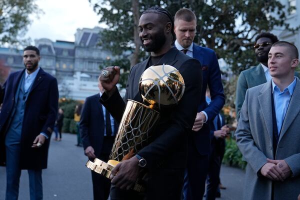 Boston Celtics player Jaylen Brown holds the Boston Celtics championship trophy following an event with President Joe Biden to celebrate the Celtics victory in the 2024 National Basketball Association Championship, on the South Lawn of the White House in Washington, Thursday, Nov. 21, 2024. (AP Photo/Susan Walsh)