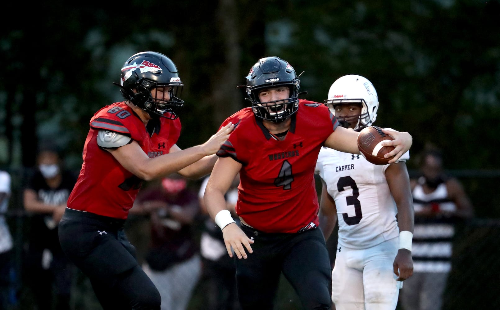 Cherokee defensive lineman Toby Thompson (4) celebrates a play with Tanner Dollyhigh (60) in the second half of their game against Carver-Atlanta at Cherokee high school Wednesday, September 2, 2020 in Canton, Ga.. JASON GETZ FOR THE ATLANTA JOURNAL-CONSTITUTION