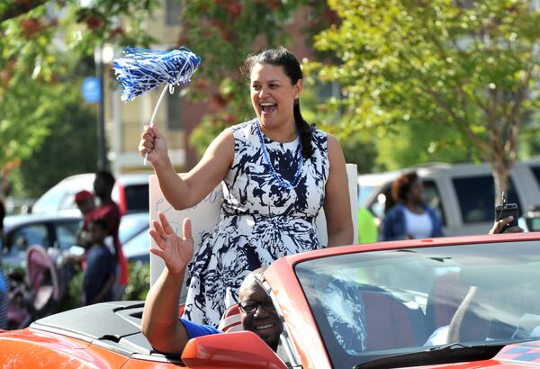 September 20, 2014 Atlanta - Atlanta Public Schools Superintendent Meria J. Carstarphen waves to spectators during the parade featuring superintendent Meria J. Carstarphen, Washington alumni and students on Martin Luther King, Jr. Drive on Saturday, September 20, 2014. As part of its homecoming festivities, Booker T. Washington High School celebrated its 90th anniversary with a parade featuring Atlanta Public Schools Superintendent Meria J. Carstarphen, Washington alumni and students. The parade began at 4:30 p.m. on Whitehouse Drive and ended at the Georgia Dome. Washington High School opened in 1924 as the first public high school for African-Americans in Georgia. Three Atlanta Public Schools football teams will participate in the 2014 APS Domecoming Football Classic Saturday, Sept. 20 at the Georgia Dome. HYOSUB SHIN / HSHIN@AJC.COM Atlanta Public Schools Superintendent Meria J. Carstarphen waves to spectators during the parade featuring superintendent at the homecoming festivities at Booker T. Washington High School. HYOSUB SHIN / HSHIN@AJC.COM