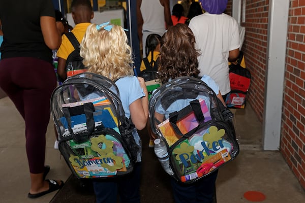 Anderson Elementary School students wear mandatory clear bookbags as they walk to classrooms during the first day of school in Clayton County in August 2022. (Jason Getz / Jason.Getz@ajc.com)