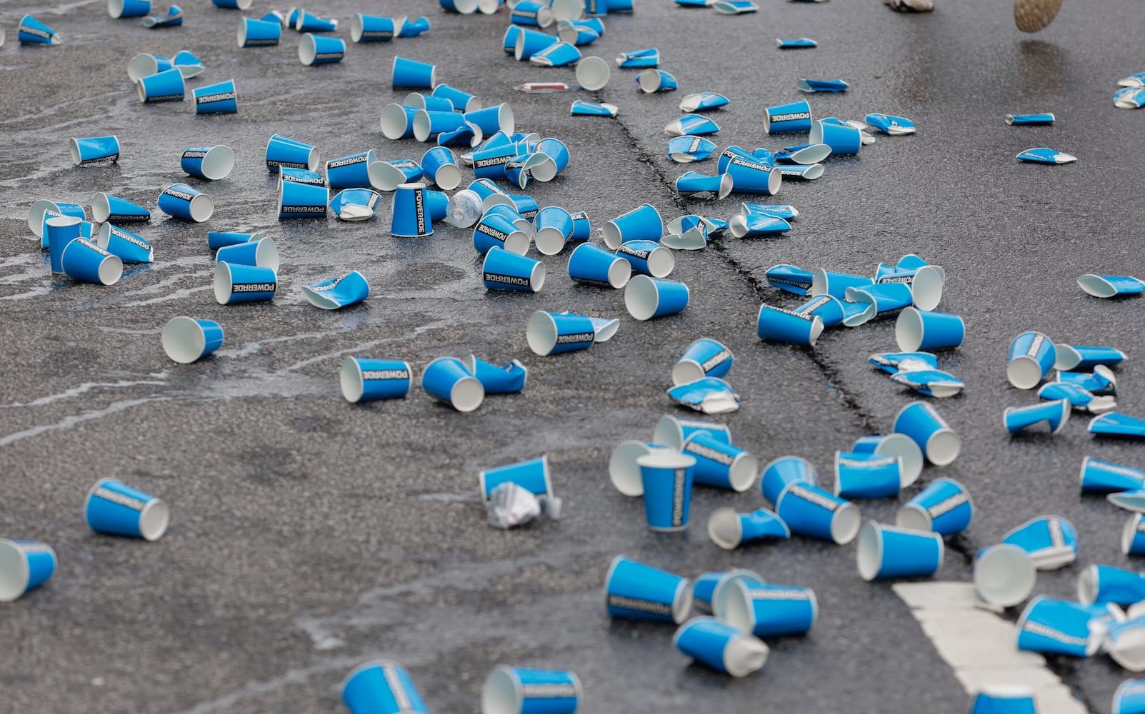 Empty water cups litter the road along Peachtree Street during the 54th running of the Atlanta Journal-Constitution Peachtree Road Race in Atlanta on Tuesday, July 4th, 2023.   (Natrice Miller / Natrice.Miller@ajc.com)