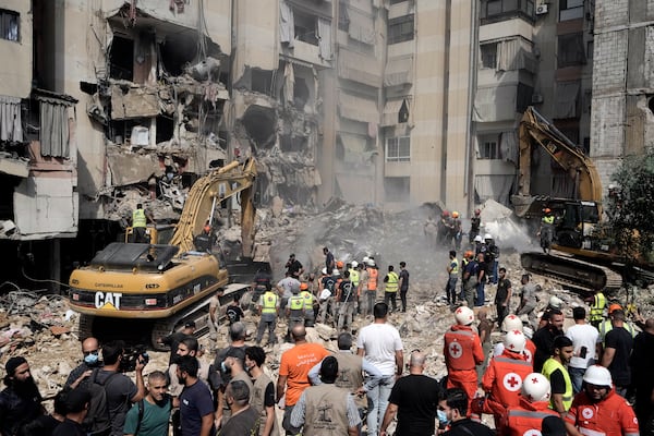 FILE - Emergency workers use excavators to clear the rubble at the site of an Israeli strike in Beirut's southern suburbs, on Sept. 21, 2024. (AP Photo/Bilal Hussein, File)