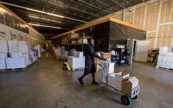 Avant Partir warehouse manager Eugene Holland works to package pallets of wine for distribution in late March. Avant Partir is a high-end wine distributor in Duluth that has seen business dry up as metro Atlanta restaurants shutter because of the coronavirus. (Jenni Girtman for The Atlanta Journal Constitution)