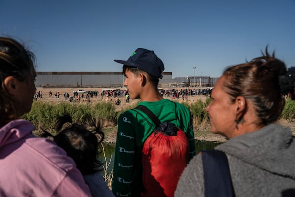 Seen from Ciudad Juarez, Mexico: asylum-seeking migrants mostly from Venezuela apprehended by U.S. Border Patrol and U.S. National Guards after crossing the Rio Grande into the U.S., on March 29, 2023. The Biden administration will start deporting Venezuelans who crossed into the country illegally, officials said Thursday, Oct. 5, 2023, in its latest attempt to stem the pace of migrants fleeing the humanitarian crisis in that country. (Go Nakamura/The New York Times)