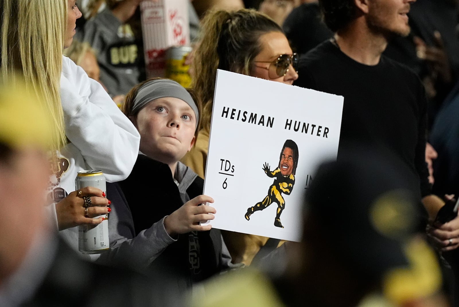 Colorado fan holds up placard for wide receiver Travis Hunter in the first half of an NCAA college football game against Kansas State Saturday, Oct. 12, 2024, in Boulder, Colo. (AP Photo/David Zalubowski)