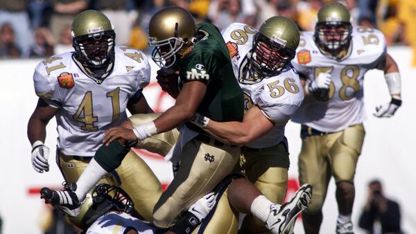 Notre Dame quarterback Jarious Jackson is sacked by Georgia Tech defender Nate Stimson (56) in the second quarter of the 1999 Toyota Gator Bowl in Jacksonville, Fla.