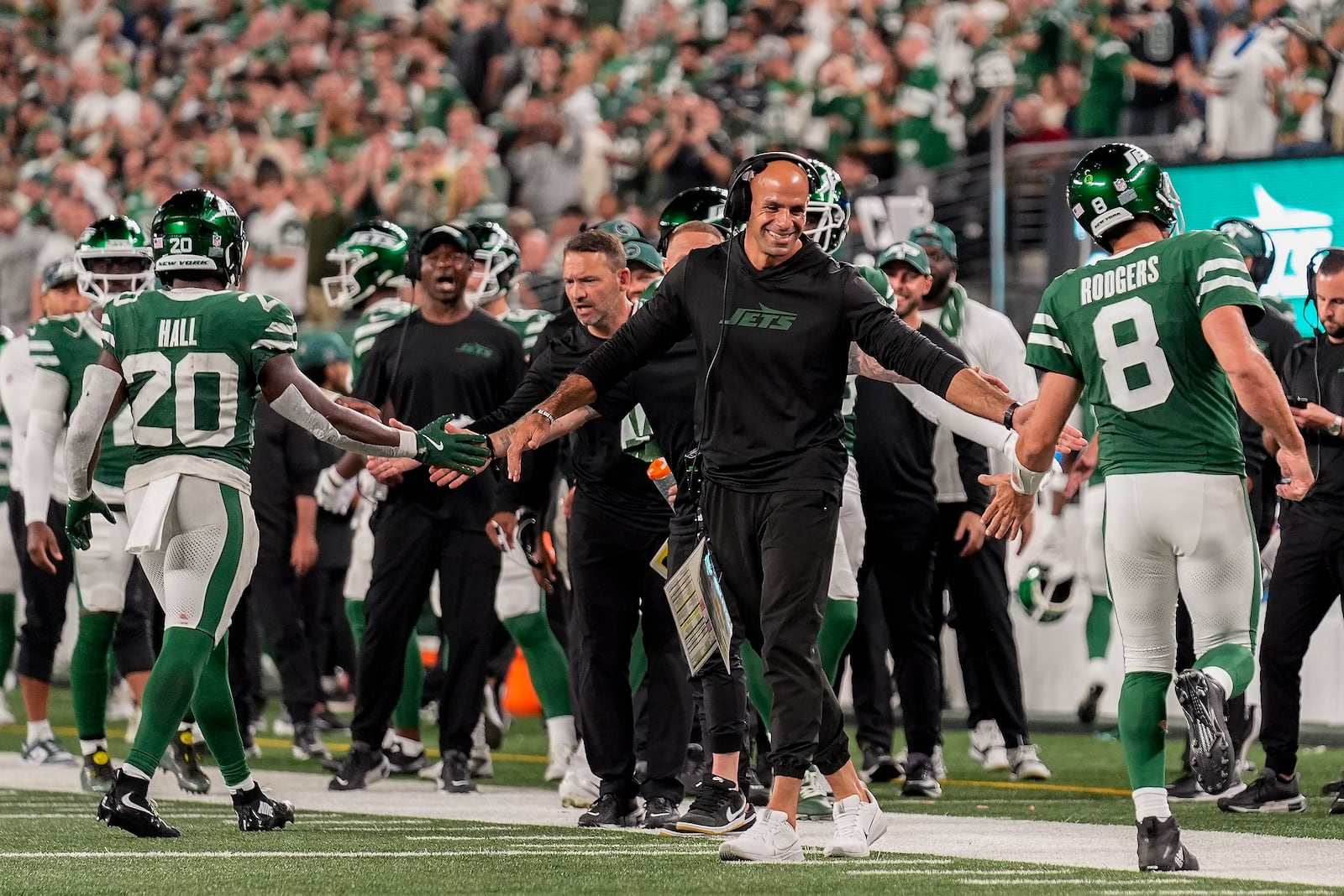 New York Jets head coach Robert Saleh congratulates New York Jets running back Breece Hall (20) and quarterback Aaron Rodgers (8) after the Jets scored a touchdown against the New England Patriots during the third quarter of an NFL football game, Thursday, Sept. 19, 2024, in East Rutherford, N.J. (AP Photo/Seth Wenig)