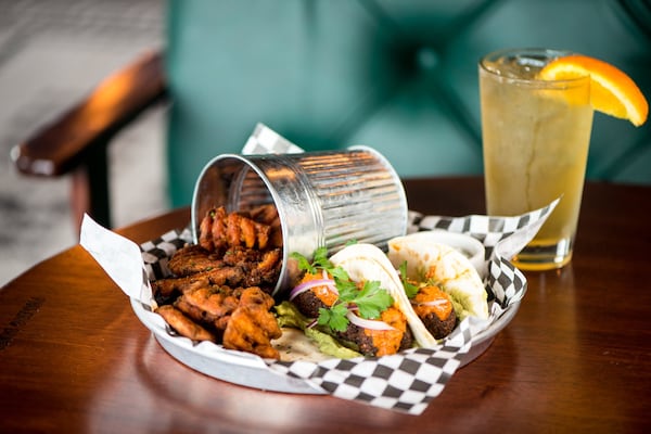 Black Sheep Tavern and Oyster Room Falafel Tacos with shaved onion, red pepper puree, avocado hummus, and sweet potato waffle fries. Photo credit- Mia Yakel.