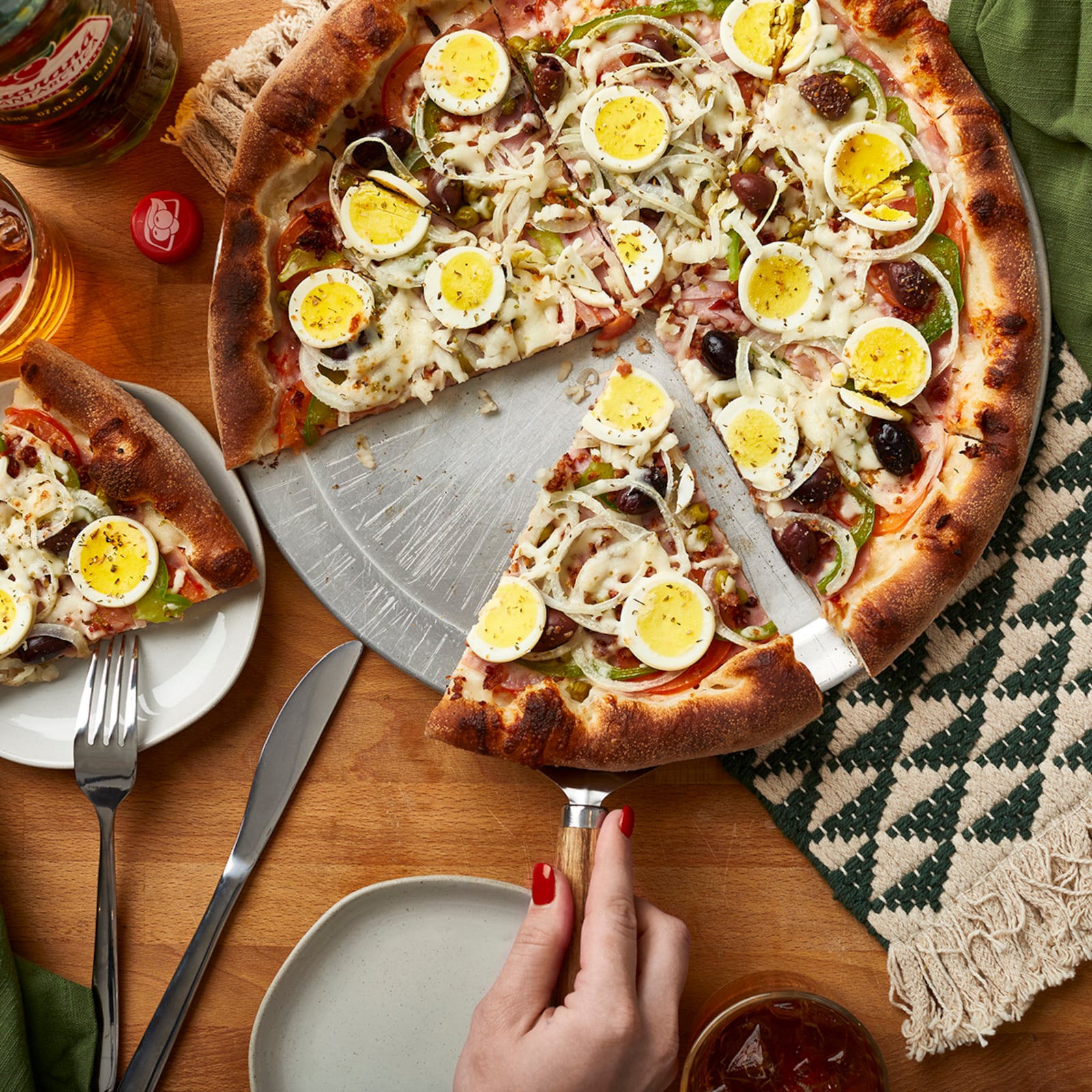 Toppings on the Portuguesa pizza from Pizza Brasiliana in the Southern Feed Store food hall in East Atlanta include hard-boiled eggs and black olives. Courtesy of Brasiliana Pizza 