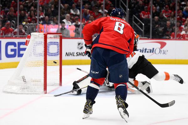 Washington Capitals left wing Alex Ovechkin (8) scores during the first period of an NHL hockey game against the Philadelphia Flyers, Thursday, March 20, 2025, in Washington. (AP Photo/Nick Wass)