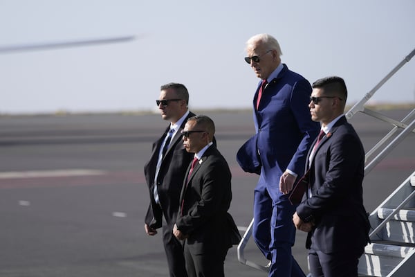 President Joe Biden walks from Air Force One at Amilcar Cabral international airport on Sal island, Cape Verde Monday, Dec. 2, 2024, en route to Angola as he makes his long-promised visit to Africa. (AP Photo/Ben Curtis)