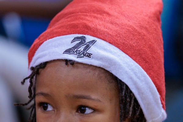 Rapper 21 Savage gives out gifts to families at the Wade Walker Park Family YMCA in Stone Mountain on Wednesday, December 21, 2022 as part of his Leading By Example Foundation. Dec. 21 was pronounced “21 Savage Day” in the state for the rapper’s philanthropic efforts. (Arvin Temkar / arvin.temkar@ajc.com)