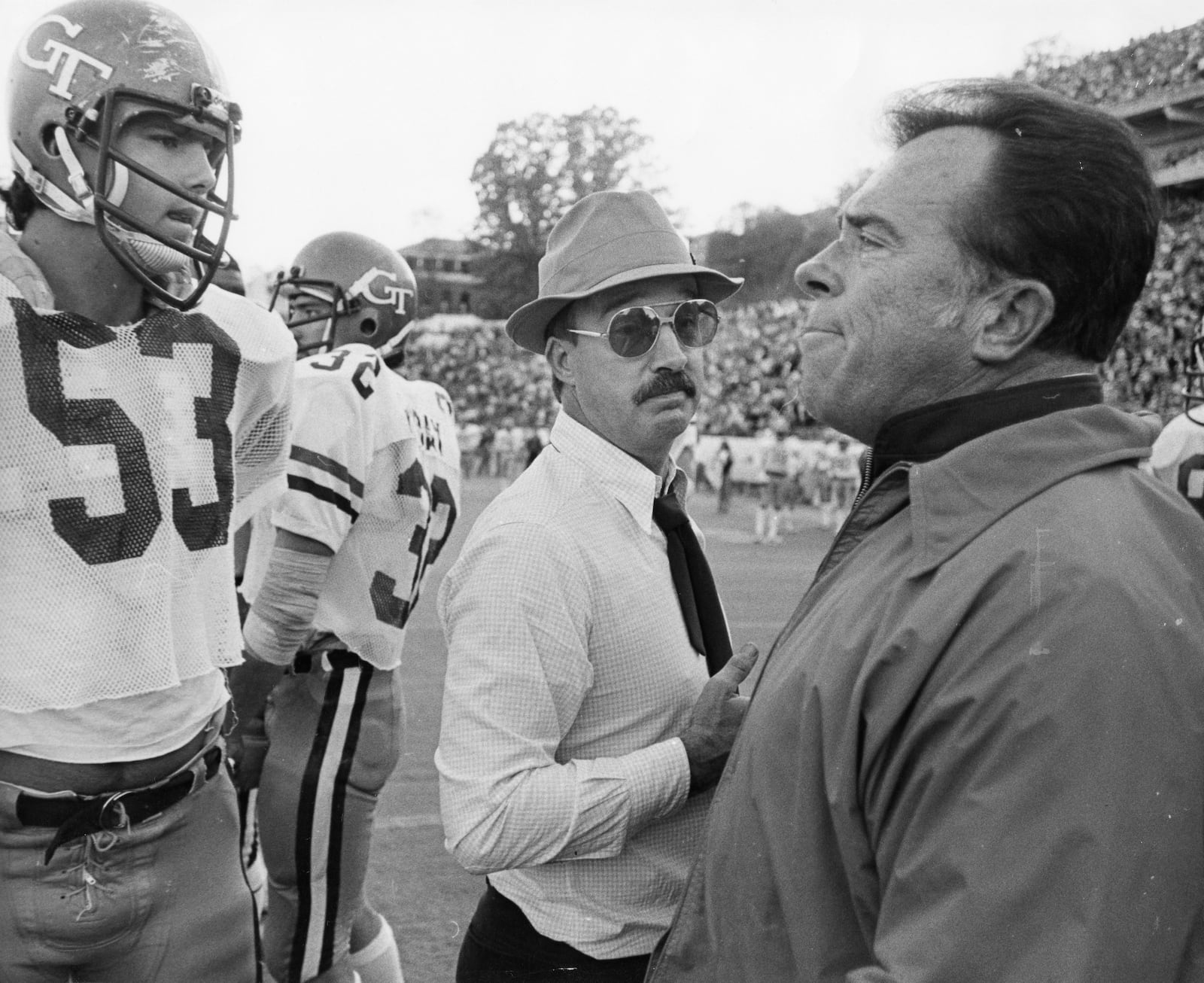 Georgia Tech coach Pepper Rodgers (middle) meets a Notre Dame coach on the field after a heated game in the 1970s. (Joe Benton / AJC)