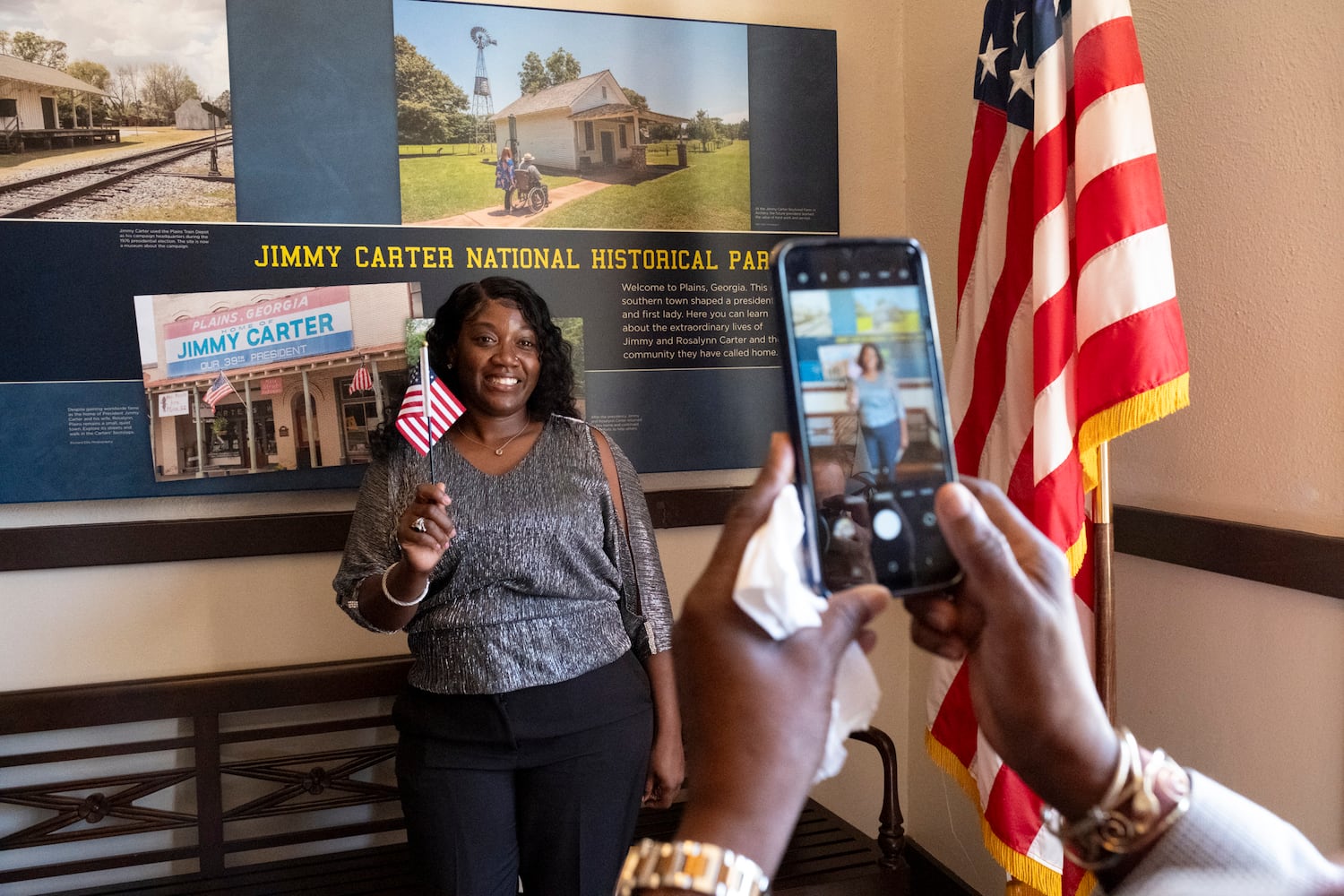 Olivia Fields, from the Bahamas, poses for a photo after becoming a U.S. Citizen during a Naturalization ceremony at Jimmy Carter National Historic Park in Plains on Tuesday, Oct. 1, 2024. The ceremony was held in honor of President Carter’s 100th birthday.  Ben Gray for the Atlanta Journal-Constitution