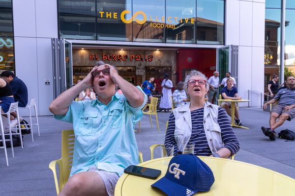 Martin Westley and Patti Willard react while watching a Wimbledon quarterfinal match watch party for Christopher Eubanks hosted by Georgia Tech at Coda Courtyard. (Arvin Temkar / arvin.temkar@ajc.com)