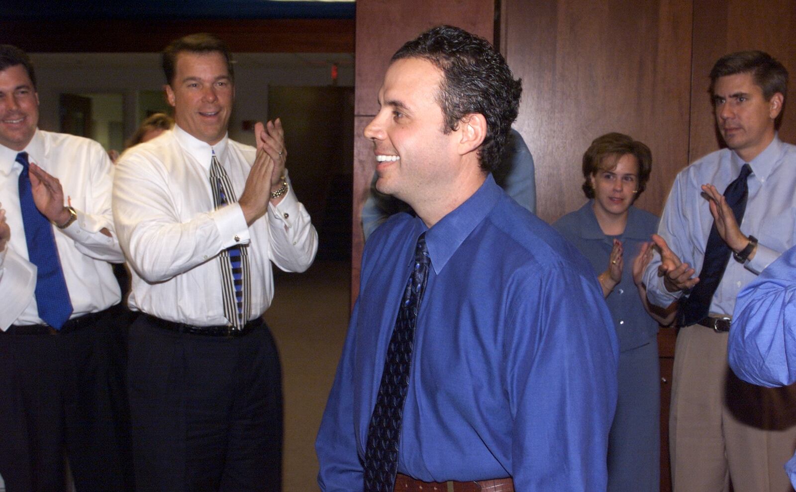 Sportscaster Fred Kalil(center) gets applause from his co-workers during a welcome back party on his first day back after recovering from brain surgery. (PHIL SKINNER /staff).