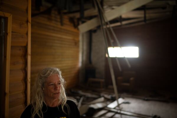 Orna Zilberstine stands at the damaged dining hall, that was hit by a rocket fired from Lebanon, in the Kibbutz Manara, northern Israel, Thursday, Nov. 28, 2024. (AP Photo/Leo Correa)