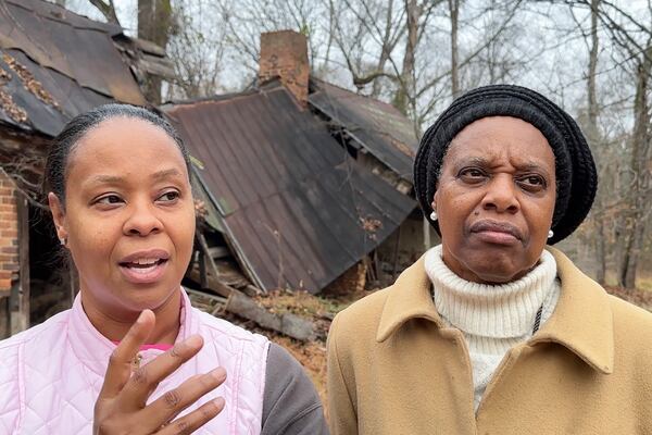 In this image made from an Associated Press video, Antoinette Adams Anderson and Ellie Clark talk about their ancestors after viewing their graves at the former Oak Hill plantation outside Danville, Va., Dec. 10, 2024. (AP Photo/Ben Finley)