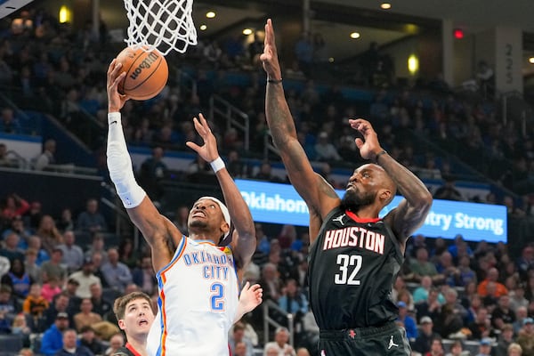 Oklahoma City Thunder guard Shai Gilgeous-Alexander (2) shoots over Houston Rockets forward Jeff Green (32) during the first half of an NBA basketball game, Monday, March 3, 2025, in Oklahoma City. (AP Photo/Kyle Phillips)