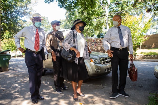 (Left to right) Walter Delaney, Sam Hall, Gwen Lawson and Herb Joseph, Jehovah's Witnesses, go door-to-door . They still take precautions like wearing masks. CHRISTINA MATACOTTA FOR THE ATLANTA JOURNAL-CONSTITUTION.