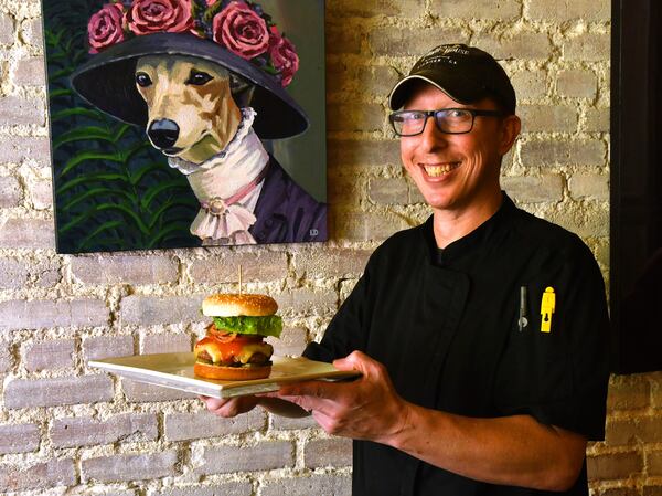 Executive chef Christian Speigal of 1910 Public House in Lilburn displays his Western Cowboy Burger. (Styling by executive chef Christian Speigal / Chris Hunt for the AJC)