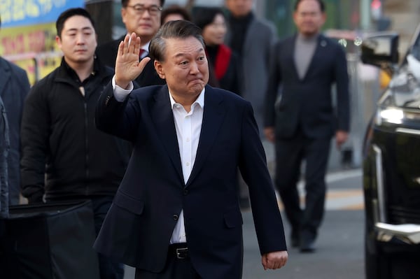 Impeached South Korean President Yoon Suk Yeol waves to his supporters as he comes out of a detention center in Uiwang, South Korea, Saturday, March 8, 2025. (Hong Hyo-shik/Newsis via AP)