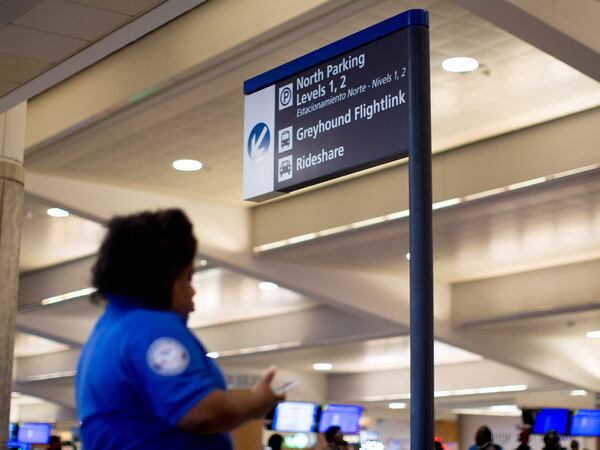 A sign is displayed directing people to a designated rideshare area where travelers can catch an Uber or Lyft ride at Hartsfield-Jackson Atlanta International Airport , Monday, Jan. 2, 2017, in Atlanta. BRANDEN CAMP/SPECIAL