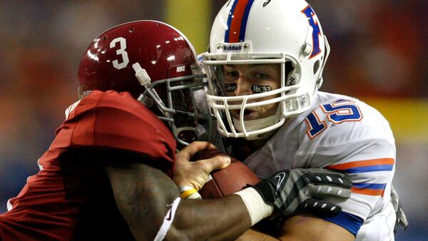 Florida quarterback Tim Tebow (15) gets pushed out of bounds by Alabama defensive back Kareem Jackson (3) on a run  in the first half of the SEC Championship game Dec. 5, 2009, at the Georgia Dome in Atlanta.