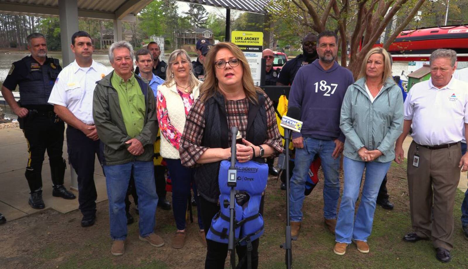 Pam Fair, executive director of Safe Kids Columbus, center, said seven life jacket loaner stations are opening March 26 around the Chattahoochee Valley where people may borrow the life jackets at no cost, and then return them at the end of the day. (Photo Courtesy of Mike Haskey)