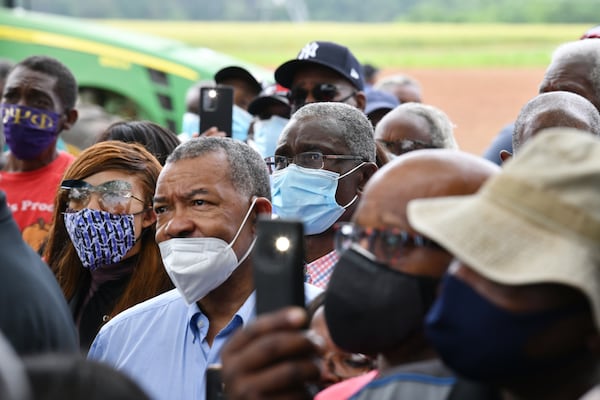 Black farmers react as U.S. Sen. Raphael Warnock speaks to them. “We’ve got confidence in him — but we aren’t playing around in Georgia,” one of the farmers said. (Hyosub Shin / Hyosub.Shin@ajc.com)