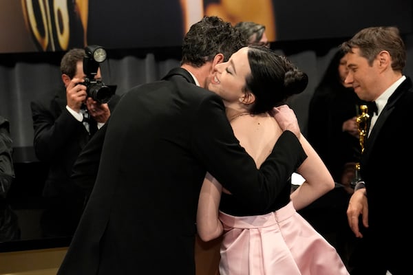 Alex Coco, left, winner of the award for best picture for "Anora," and Mikey Madison, winner of the award for best performance by an actress in a leading role for "Anora," embrace at the Governors Ball after the Oscars on Sunday, March 2, 2025, in Los Angeles. (AP Photo/John Locher)